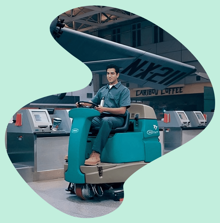 Man operating a ride on floor scrubber for floor scrubber rental Dothan AL