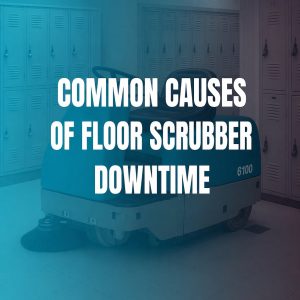 Teal ride-on floor scrubber parked in locker room illustrating common causes of scrubber downtime