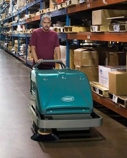 Cleaning staf using walk behind sweepers from Thompson Flooring Solutions